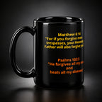Black mug with yellow and orange scripture text on a white background