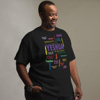 A man wearing a black t-shirt with a colorful word cloud graphic featuring the name 'Yeshua' and biblical titles, posed against a neutral gray studio background.